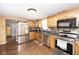 Well-equipped kitchen with stainless steel appliances, ample cabinetry, and hardwood floors for a modern look at 605 Brentwood E Dr, Plainfield, IN 46168