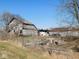 Rustic barn exterior, showcasing weathered wood, a sturdy structure, and open land; needs TLC at 13205 E Legal Tender Rd, Columbus, IN 47203