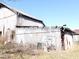 A rustic barn with aged wooden planks, exposed beams, and some debris in the front at 13205 E Legal Tender Rd, Columbus, IN 47203