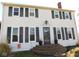 Charming two-story home featuring classic shutters and a welcoming brick entryway at 13205 E Legal Tender Rd, Columbus, IN 47203