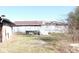 Rear view of several buildings and outbuildings; structures with a metal roof appear to be in poor condition at 13205 E Legal Tender Rd, Columbus, IN 47203