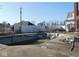 Backyard featuring an empty inground pool requiring maintenance, with the house in the background at 13205 E Legal Tender Rd, Columbus, IN 47203