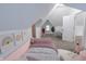 Charming attic bedroom with a built in desk and a pink daybed at 48 N Colorado Ave, Indianapolis, IN 46201
