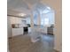 Modern kitchen with white cabinets, stainless steel appliances, and wood-look flooring at 48 N Colorado Ave, Indianapolis, IN 46201