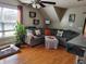 Spacious living room featuring hardwood floors, gray sectional sofa, and large window at 2133 N Park Ave, Indianapolis, IN 46202