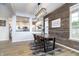 Dining room with a rustic wood feature wall and modern light fixture at 10561 Sand Creek Blvd, Fishers, IN 46037