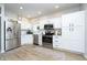 Modern kitchen with white cabinets, stainless steel appliances, and granite countertops at 10561 Sand Creek Blvd, Fishers, IN 46037