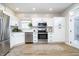 Modern kitchen with white cabinets, stainless steel appliances, and granite countertops at 10561 Sand Creek Blvd, Fishers, IN 46037