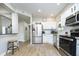 Modern kitchen with white cabinets, stainless steel appliances, and granite countertops at 10561 Sand Creek Blvd, Fishers, IN 46037