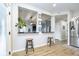 Kitchen features a breakfast bar with two stools and a view into the living room at 10561 Sand Creek Blvd, Fishers, IN 46037