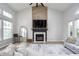 Living room with a fireplace, vaulted ceiling, and large windows at 10561 Sand Creek Blvd, Fishers, IN 46037