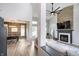 Spacious living room with a fireplace, wood accent wall, and large windows at 10561 Sand Creek Blvd, Fishers, IN 46037