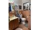 A well lit bathroom with a sink, toilet, and open shelves at 3141 W 33Rd St, Indianapolis, IN 46222