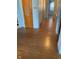 A hallway with wood flooring, doors, and neutral colored walls at 3141 W 33Rd St, Indianapolis, IN 46222