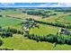 Aerial view of a property highlighting the expansive land with lush greenery and mature trees at 13208 State Road 32 E, Noblesville, IN 46060
