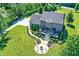 Aerial view of brick home with manicured lawn and landscaping, including fire pit at 13208 State Road 32 E, Noblesville, IN 46060