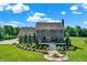 Spacious backyard featuring a patio, fire pit, and lush landscaping with beautiful trees at 13208 State Road 32 E, Noblesville, IN 46060