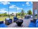 A beautiful backyard deck featuring a fire pit and outdoor seating under string lights at 13208 State Road 32 E, Noblesville, IN 46060