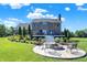 Backyard with brick home and fire pit surrounded by beautiful landscaping at 13208 State Road 32 E, Noblesville, IN 46060