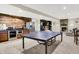 Finished basement featuring a kitchenette, ping pong table, stone fireplace, and comfortable seating area at 13208 State Road 32 E, Noblesville, IN 46060