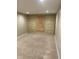 Spacious finished basement featuring wood accent wall and new carpet at 13208 State Road 32 E, Noblesville, IN 46060