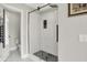 Bathroom with a modern walk-in shower, glass door, and hexagon tile accents at 13208 State Road 32 E, Noblesville, IN 46060