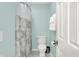 Clean bathroom featuring a toilet, shower with curtain, and white tile flooring for a fresh look at 13208 State Road 32 E, Noblesville, IN 46060