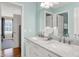 Bathroom featuring a double sink vanity with marble countertops and modern fixtures, and view to another room at 13208 State Road 32 E, Noblesville, IN 46060