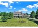 A beautiful brick home with a well-manicured lawn and vibrant flower beds at 13208 State Road 32 E, Noblesville, IN 46060