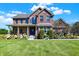 A beautiful brick home with a well-manicured lawn and lush hydrangea bushes at 13208 State Road 32 E, Noblesville, IN 46060