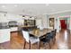 Spacious kitchen and dining area with modern lighting, black island, and stainless-steel appliances at 13208 State Road 32 E, Noblesville, IN 46060