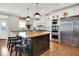 Well-lit kitchen with butcher block island, stainless steel appliances, and white cabinets at 13208 State Road 32 E, Noblesville, IN 46060