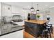 Bright kitchen featuring white cabinetry, black countertops, a butcher block island, and stainless steel appliances at 13208 State Road 32 E, Noblesville, IN 46060