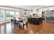 Open kitchen and dining area filled with natural light, an island with stools, and stainless steel appliances at 13208 State Road 32 E, Noblesville, IN 46060