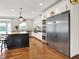 White kitchen boasts stainless steel appliances, a butcher block island, and plenty of natural light at 13208 State Road 32 E, Noblesville, IN 46060