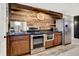 Basement kitchenette with stainless steel appliances, wooden cabinets, and granite countertops at 13208 State Road 32 E, Noblesville, IN 46060