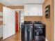 Well-equipped laundry room featuring modern washer and dryer with a bright red accent door at 13208 State Road 32 E, Noblesville, IN 46060