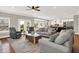 Open-concept living area with a decorative rug, grey seating, and a view of the kitchen at 13208 State Road 32 E, Noblesville, IN 46060