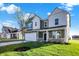 Two-story house with green and white siding, a tree in the front yard, and a grassy lawn at 573 Carroll St, New Whiteland, IN 46184