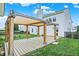 Inviting backyard with a wooden pergola, outdoor lighting, and a well-manicured lawn at 1560 Cold Spring Dr, Brownsburg, IN 46112