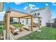 Inviting backyard patio with stylish pergola, comfortable seating, and outdoor grill, perfect for relaxation and entertaining at 1560 Cold Spring Dr, Brownsburg, IN 46112