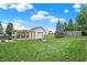 Expansive backyard with a pergola, detached garage, fire pit, and well-maintained lawn at 1560 Cold Spring Dr, Brownsburg, IN 46112