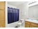 Clean bathroom featuring blue shower curtain, toilet, and vanity area, and plenty of storage at 1560 Cold Spring Dr, Brownsburg, IN 46112
