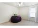 Minimalist bedroom with a large beanbag chair and natural light from the window at 1560 Cold Spring Dr, Brownsburg, IN 46112
