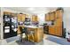 Well-lit kitchen features wood cabinets, stainless steel appliances, a center island with breakfast bar and hardwood floors at 1560 Cold Spring Dr, Brownsburg, IN 46112