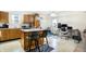 The kitchen area has stainless steel appliances, wood cabinets, a center island with breakfast bar and plenty of workspace at 1560 Cold Spring Dr, Brownsburg, IN 46112
