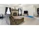 Spacious living room featuring neutral carpet, ceiling fan, large fireplace, and sliding glass door to the backyard at 1560 Cold Spring Dr, Brownsburg, IN 46112