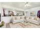 Bright living room with white sofas, a decorative rug, and a glimpse into the open floor plan, perfect for modern living at 1560 Cold Spring Dr, Brownsburg, IN 46112
