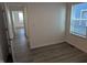 Bedroom with hard surface flooring and large window overlooking a residential neighborhood at 3636 Salem St, Indianapolis, IN 46208