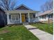 Charming home featuring a welcoming front porch with white columns and a bright yellow front door at 3636 Salem St, Indianapolis, IN 46208